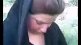 Uninhibited Arab Hijab-Wearing Woman Indulges In Outdoor Pleasure