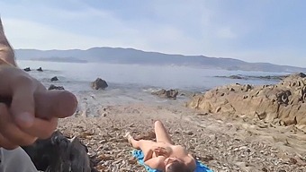 A Nudist Milf Receives A Flash From An Exhibitionist On The Beach